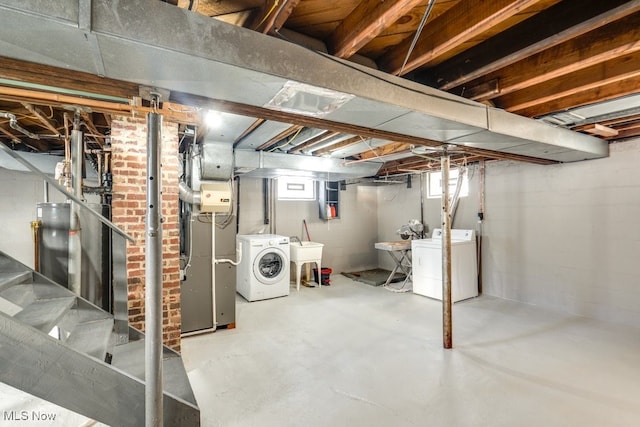 basement featuring a sink and independent washer and dryer