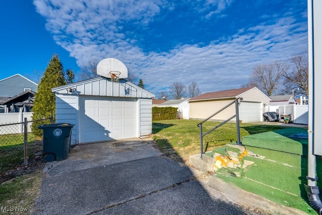 detached garage with driveway and fence