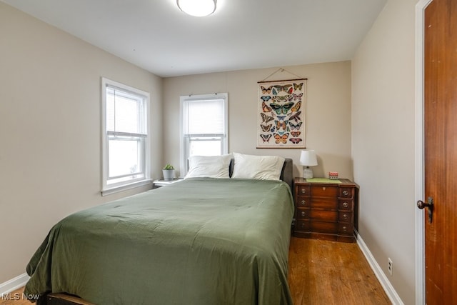 bedroom with wood finished floors and baseboards