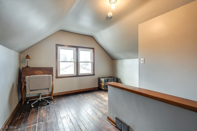 unfurnished office featuring lofted ceiling, baseboards, visible vents, and dark wood-style flooring