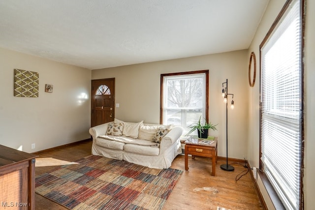 living area featuring light wood-type flooring and baseboards