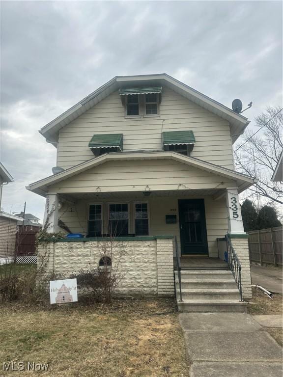 american foursquare style home featuring fence