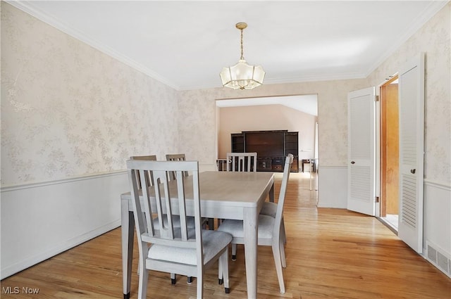 dining area with wallpapered walls, light wood-style flooring, visible vents, and a chandelier