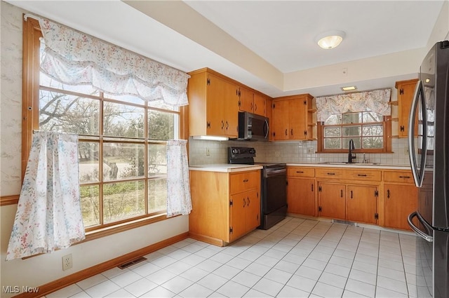 kitchen featuring light countertops, appliances with stainless steel finishes, a sink, and visible vents