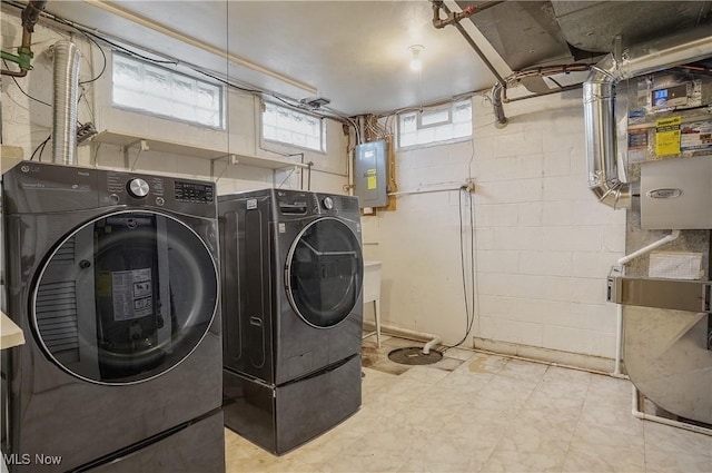 laundry area featuring laundry area, electric panel, separate washer and dryer, and light floors