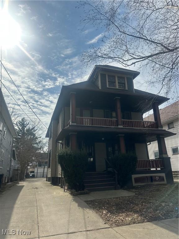 view of front of home with a porch and a balcony