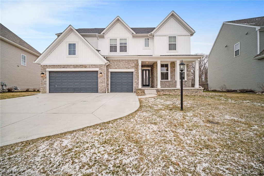 modern farmhouse style home with an attached garage, covered porch, stone siding, driveway, and board and batten siding