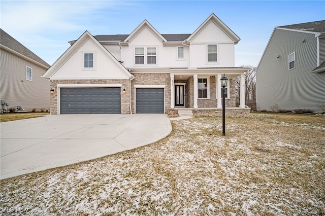 modern farmhouse style home with an attached garage, covered porch, stone siding, driveway, and board and batten siding