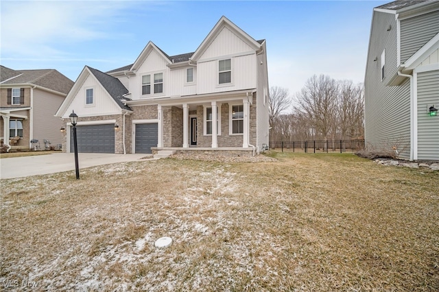 view of front of property featuring a garage, driveway, covered porch, fence, and board and batten siding