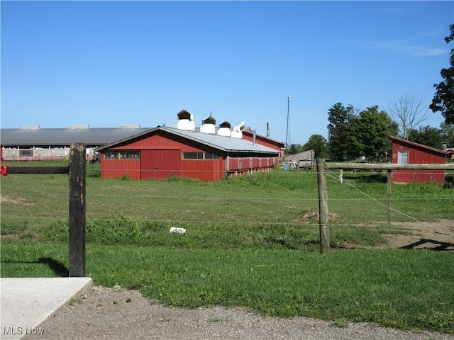 view of yard with an outbuilding and fence