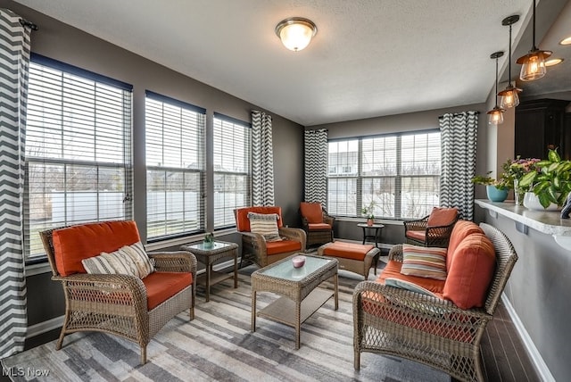 living area featuring a healthy amount of sunlight and baseboards