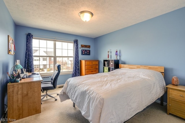 bedroom with a textured ceiling and carpet flooring