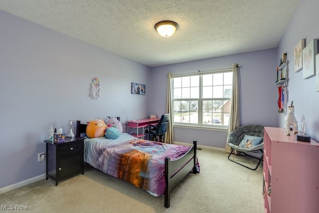 carpeted bedroom featuring a textured ceiling and baseboards