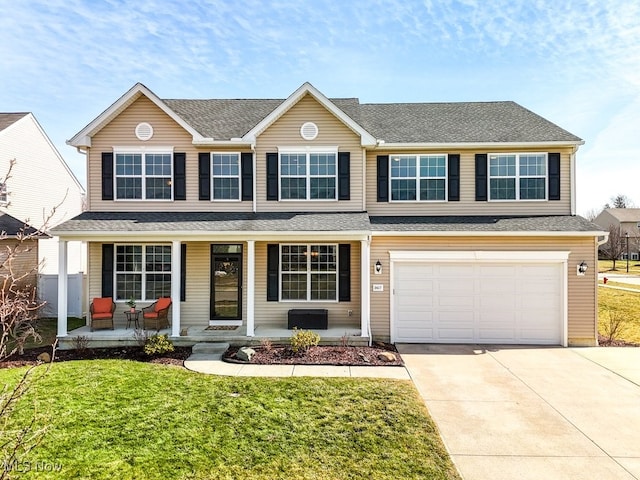 view of front of house featuring a garage, driveway, a shingled roof, covered porch, and a front yard