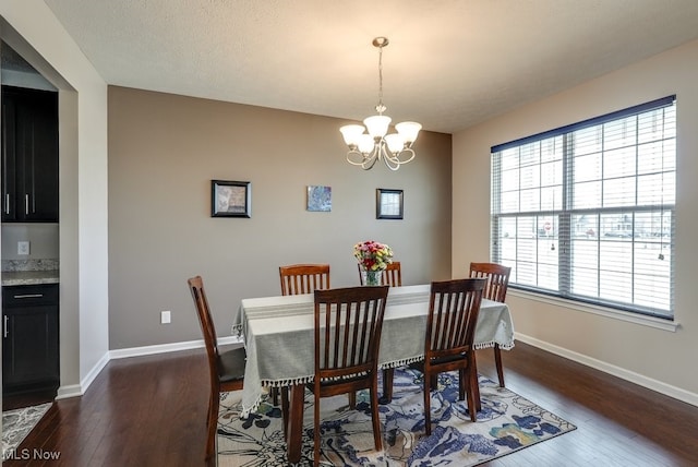 dining space featuring baseboards, a textured ceiling, a chandelier, and dark wood-style flooring