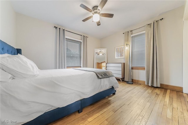 bedroom featuring wood-type flooring, baseboards, and ceiling fan