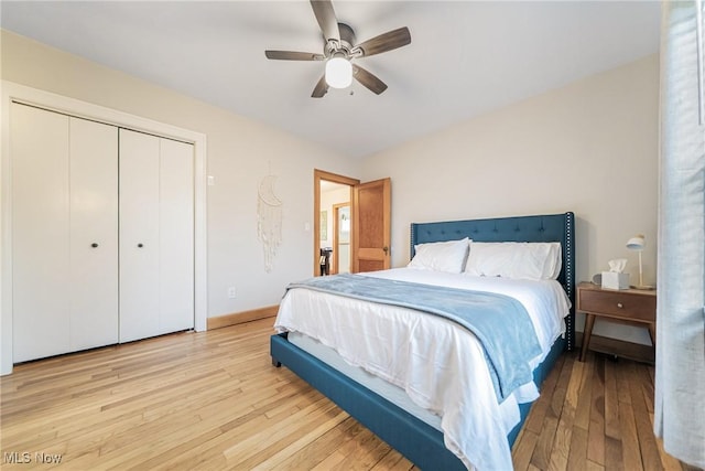 bedroom with a closet, light wood-type flooring, a ceiling fan, and baseboards