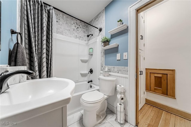 bathroom with a sink, shower / bathing tub combination, and toilet