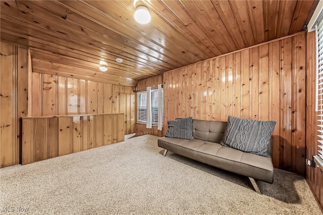 living area featuring wood ceiling, carpet flooring, and wood walls