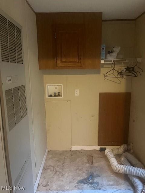 clothes washing area featuring cabinet space, a heating unit, and washer hookup