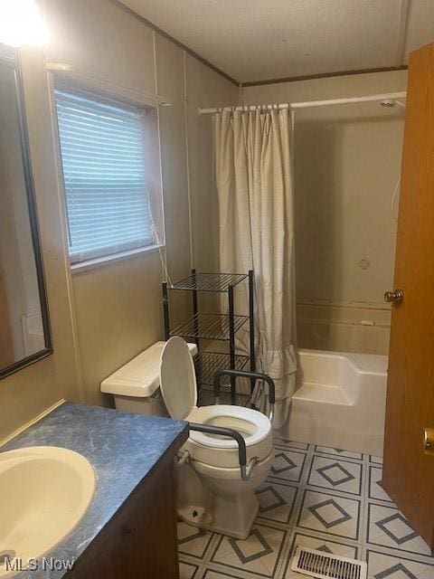 bathroom featuring vanity, toilet, and shower / bath combo with shower curtain