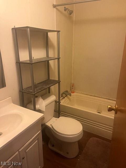 bathroom with tub / shower combination, vanity, and toilet