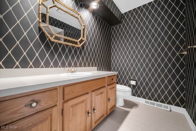 bathroom featuring visible vents, vanity, and toilet