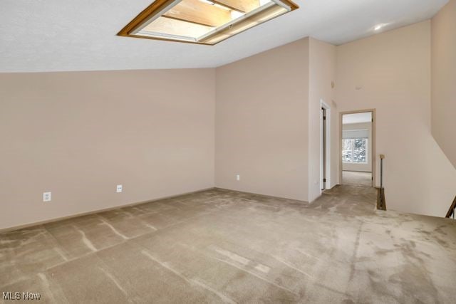 interior space with carpet floors and vaulted ceiling