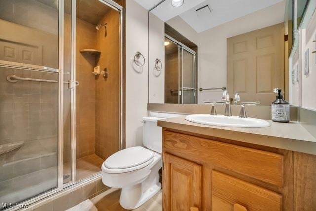 full bath featuring toilet, a stall shower, visible vents, and vanity