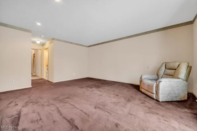 unfurnished room featuring ornamental molding and carpet floors