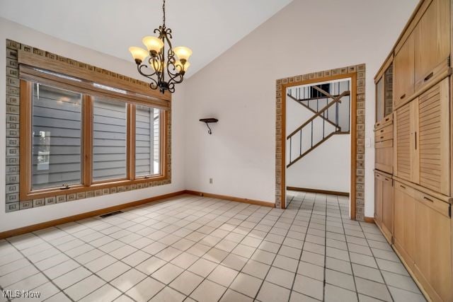 unfurnished dining area with a notable chandelier, light tile patterned floors, lofted ceiling, visible vents, and stairway