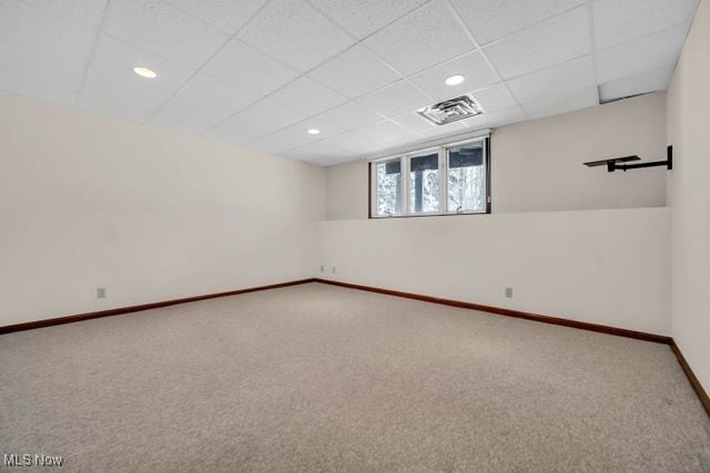 empty room with visible vents, baseboards, carpet, a paneled ceiling, and recessed lighting