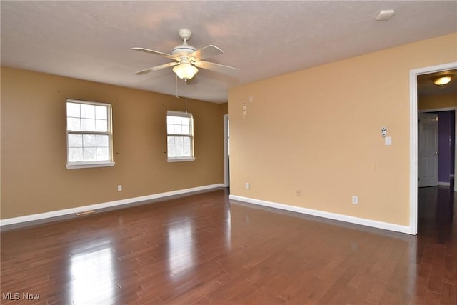 unfurnished room with ceiling fan, baseboards, and wood finished floors