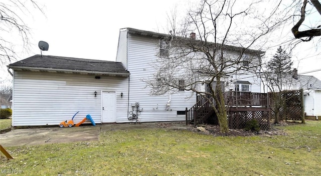 rear view of house featuring a yard, a patio area, and a wooden deck