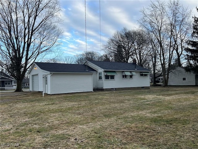 rear view of house featuring a yard