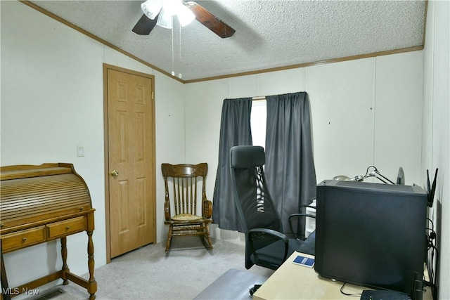 carpeted home office featuring a textured ceiling, lofted ceiling, a ceiling fan, and crown molding