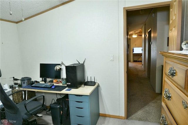 office featuring ceiling fan, ornamental molding, a textured ceiling, and light colored carpet