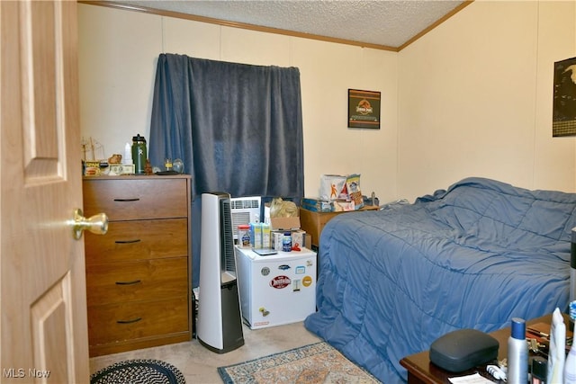 bedroom with ornamental molding, light carpet, and a textured ceiling