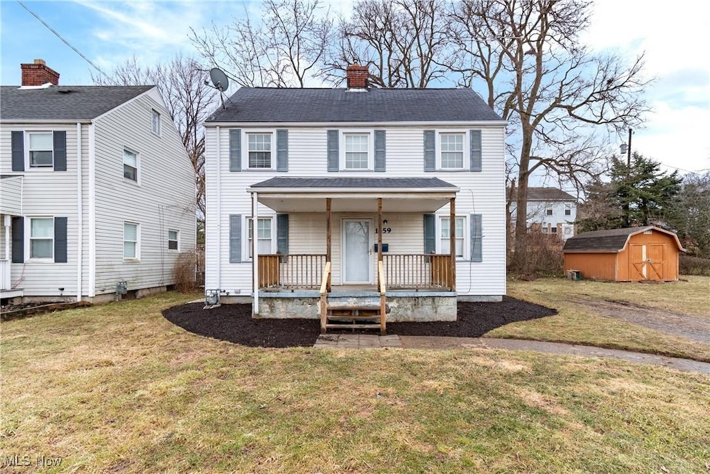 1359 Roslyn Ave SW, Canton, OH 44710 - view of front of house featuring a chimney, covered porch, an outdoor structure, a shed, and a front lawn