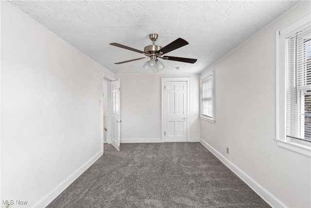 unfurnished bedroom featuring multiple windows, baseboards, and carpet flooring