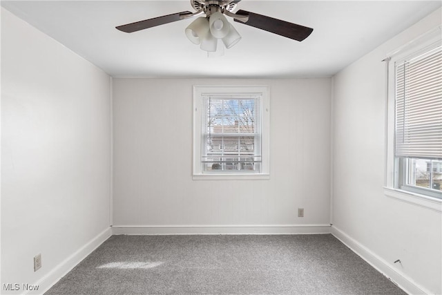 spare room featuring a ceiling fan, baseboards, and carpet flooring