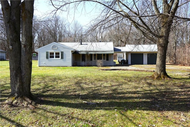 ranch-style home with a garage, covered porch, and a front lawn