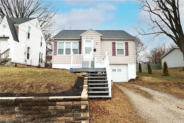 bungalow-style house featuring roof with shingles, dirt driveway, stairway, a front yard, and a garage