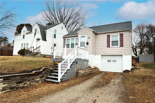 view of front facade featuring an attached garage, driveway, and roof with shingles