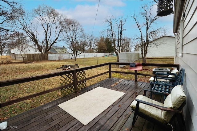 wooden terrace with a fenced backyard and a lawn