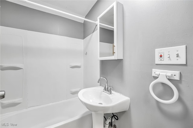 bathroom featuring shower / tub combination and a sink