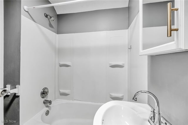 bathroom featuring  shower combination and a sink