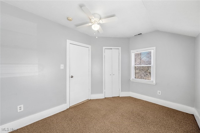 unfurnished bedroom with a closet, visible vents, carpet flooring, ceiling fan, and baseboards