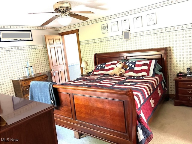 bedroom with carpet flooring, a ceiling fan, and wallpapered walls