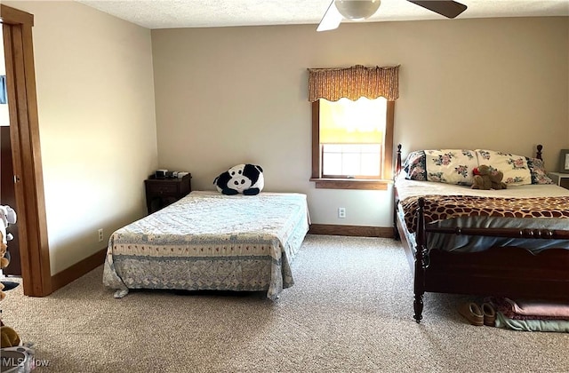 bedroom with a textured ceiling, carpet floors, a ceiling fan, and baseboards